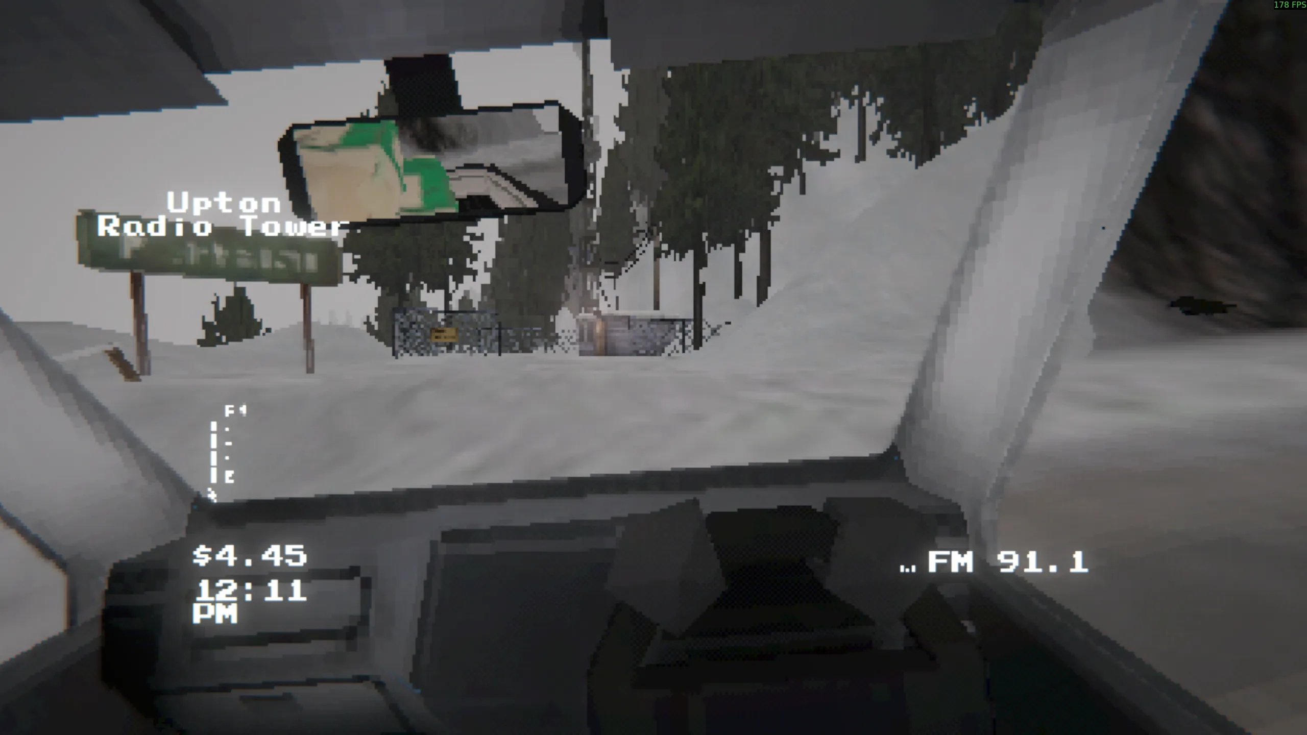 First-person view inside the truck. It's daytime again, and the truck is climbing up a mound of snow toward a small shack with a radio tower next to it. A street sign says "Upton Radio Tower".